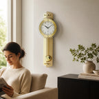 Standuhren.com 🕰️ AMS F5267 Funk-Pendelwanduhr mit goldener Messing-Applikation und Holzrückwand in einem Wohnzimmer